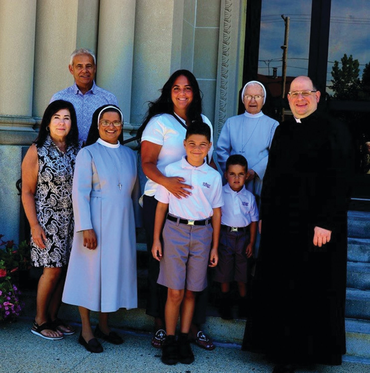 WELCOME WELCOME: Rev. Fr. Carusi Sr., Daisy and Sr. Mary Antoinette welcome the Vieira family to the St. Rocco Feast Mass.